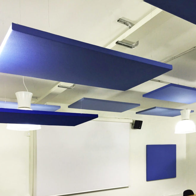 Acoustic panels hanging from the ceiling with a v edge