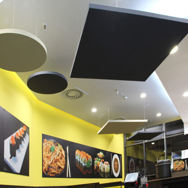 Coloured sound absorbing panels suspended from the ceiling