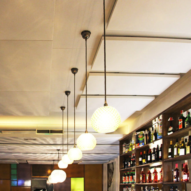 Square sound absorbing ceiling panels in a restaurant