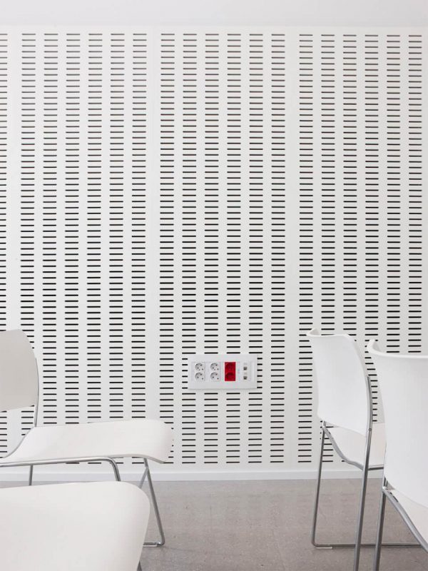 Slatted wooden sound absorbing panels lacquered of white