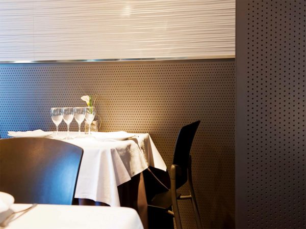 Perforated wood wall panels in a restaurant