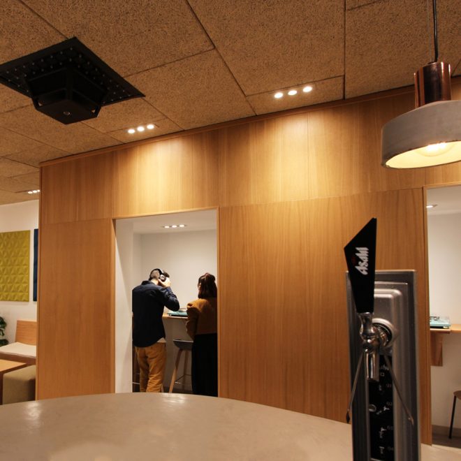 Acoustic wall covered with micro perforated wood in a club