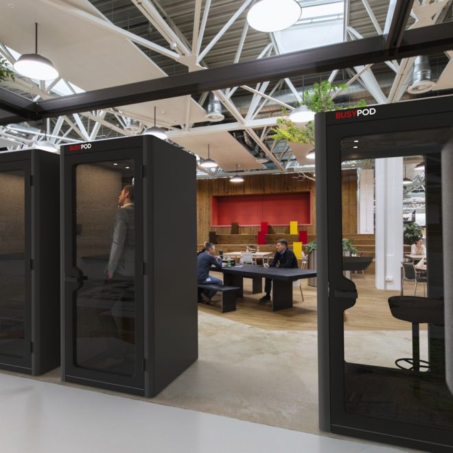 Individual phone booths with sound proofing panels in a bar