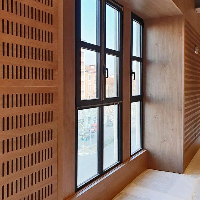 Acoustic wall of an office with wooden  slatted panels